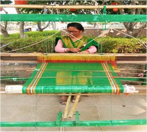 Smt. Nandini Mochahary Vill & P.O: Khagrabari Dist: Chirang, BTR Contact No. 9613175570 She  has set up her own handloom industry at home after availing Mudra loan of Rs. 50,000/- in the year 2019-20. She is producing clothes (than) for garment making and is earning net profit of Rs. 7470.00 per month.
